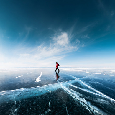 A man walking on a frozen lake.